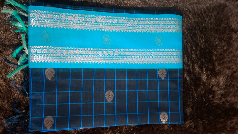 Dark blue cotton silk saree with turquoise checks, metallic motifs and a turquoise section with decorative bands and tassels