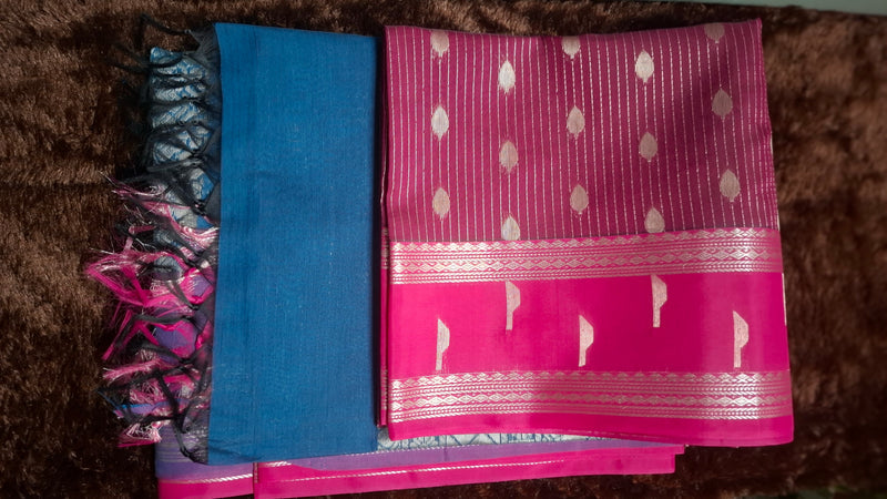 Pink cotton silk saree with fine metallic-tone stripes and motifs, a decorative pink border and blue pallu