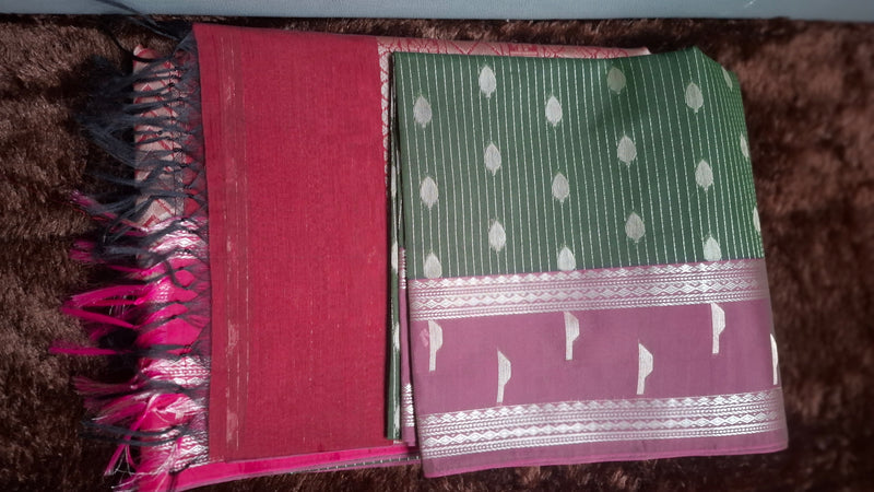 Dark green cotton silk saree with silver-tone stripes and motifs, maroon pallu, decorative border and tassels